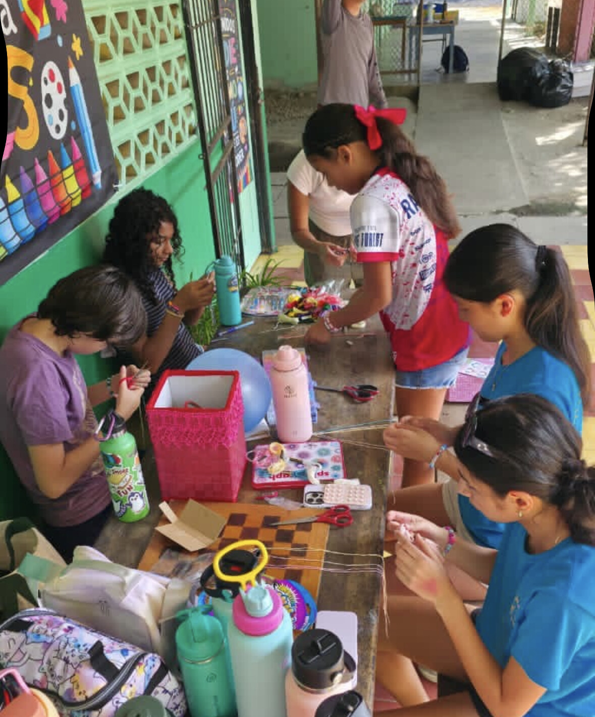 Making friendship bracelets with kids at the school