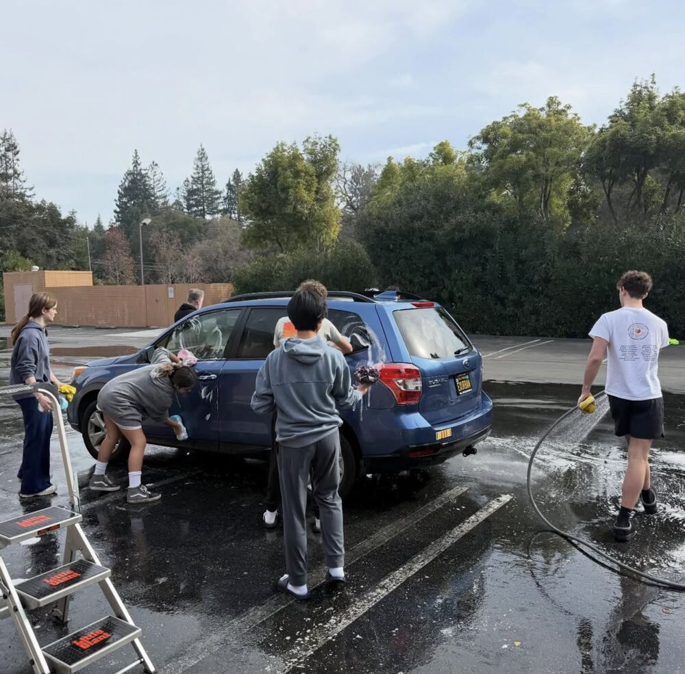 Students washing a car for a fundraiser